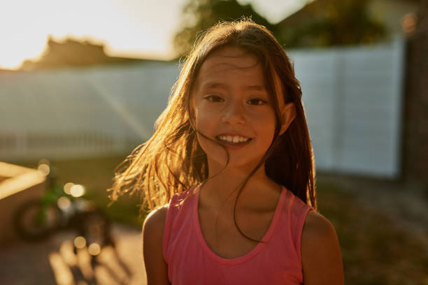 Portrait of a happy girl playing outside in the backyard