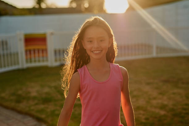 Portrait of a happy girl playing outside in the backyard