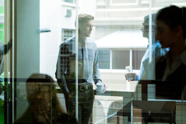 istock Businessmen seen through glass during coffee break 641732534