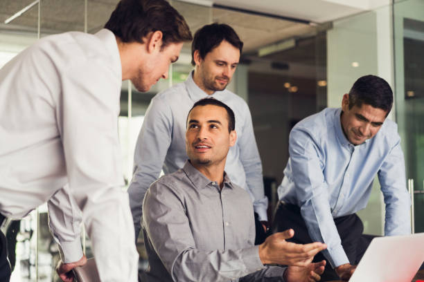 istock Businessmen using laptop in board room 641732546