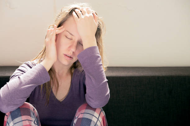 istock Stressed young woman sitting on sofa 641732658