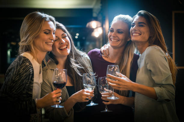 istock Cheerful female friends enjoying drinks in bar 641732914