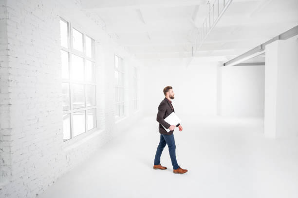 istock Businessman in the white office interior 641733644