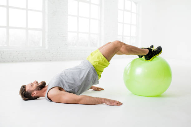 istock Man exercising with fitball 641737516