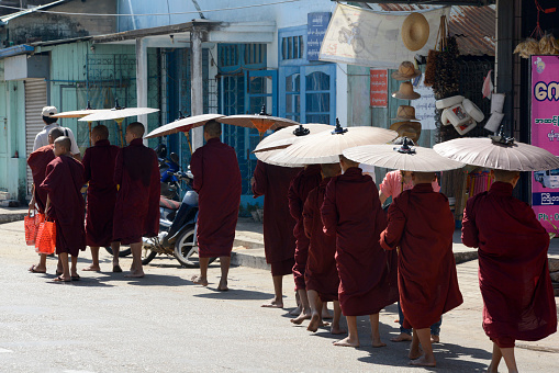 Monks on the road in the city centre of Myeik in the south in Myanmar in Southeastasia.