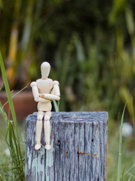 istock Wooden Man - Lonely figure sitting alone 641742686