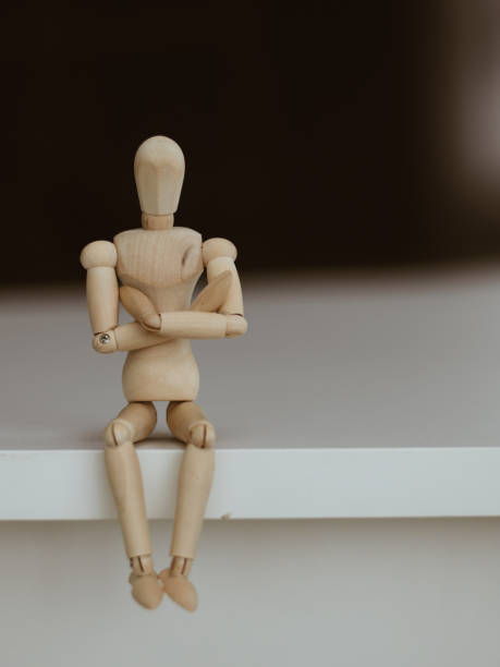 istock Wooden Man - Lonely figure sitting alone 641743194