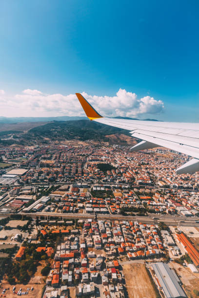 istock Airplane Wing in Flight on City 641744754