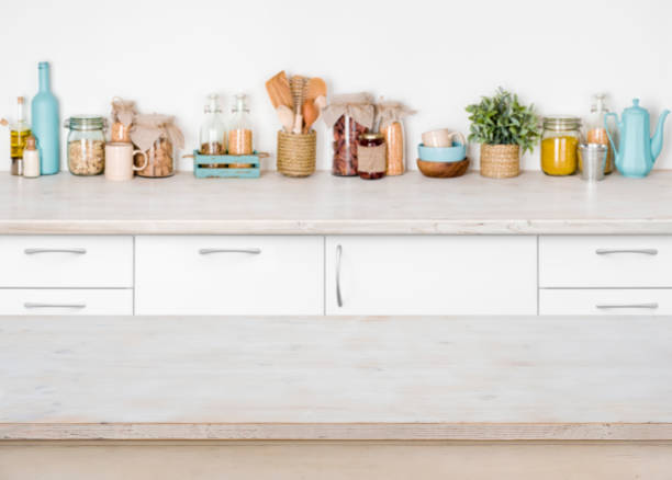 istock Empty wooden kitchen table on blurred background of food ingredients 641745546