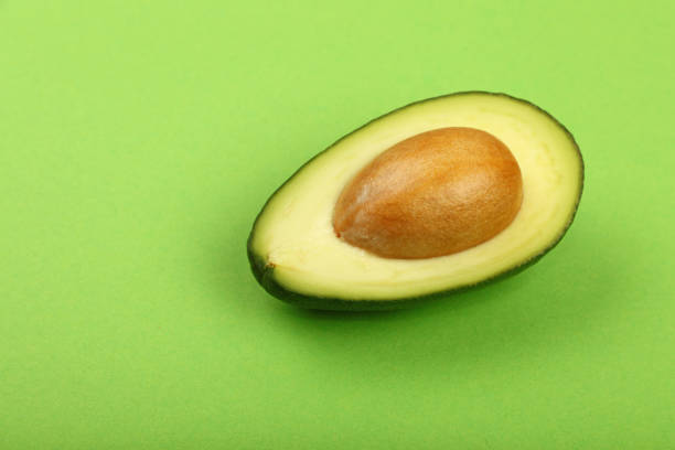 istock Fresh ripe avocado on green paper 641747350