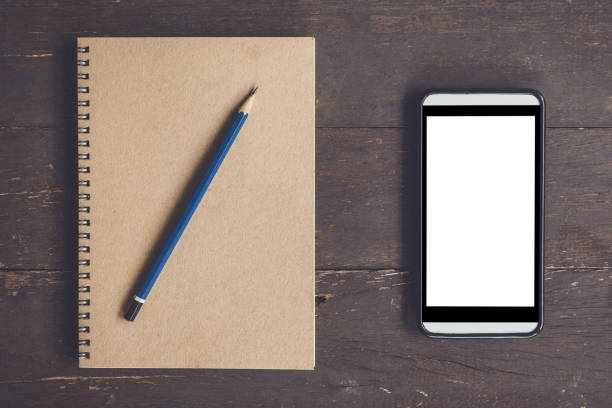 istock Blank notebook and phone blank screen for advertising on wood table background with space. 641748694