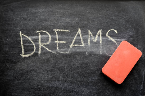 istock erasing dreams, hand written word on blackboard being erased concept 641750242