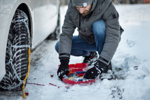 istock Mounting snow chains on a car tire 641750284