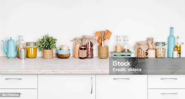 Kitchen Bench Interior With Various Herbs Spices Utensils On White Stock Photo - Download Image Now