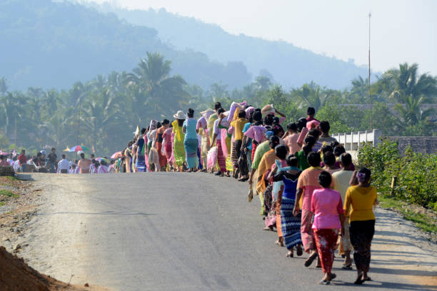 People in traditional dresses at a shinpyu ceremony in a village neat the city of Myeik in the south in Myanmar in Southeastasia.