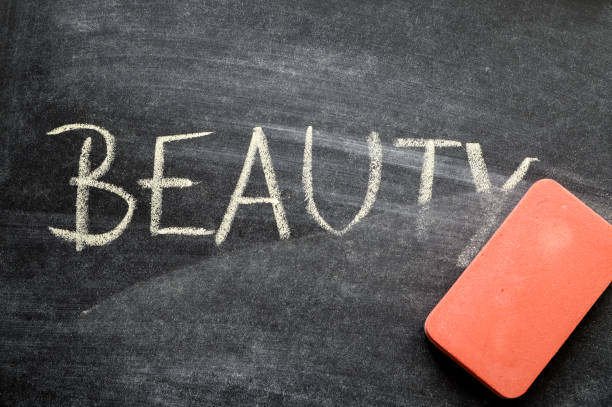 istock erasing beauty, hand written word on blackboard being erased concept 641751896