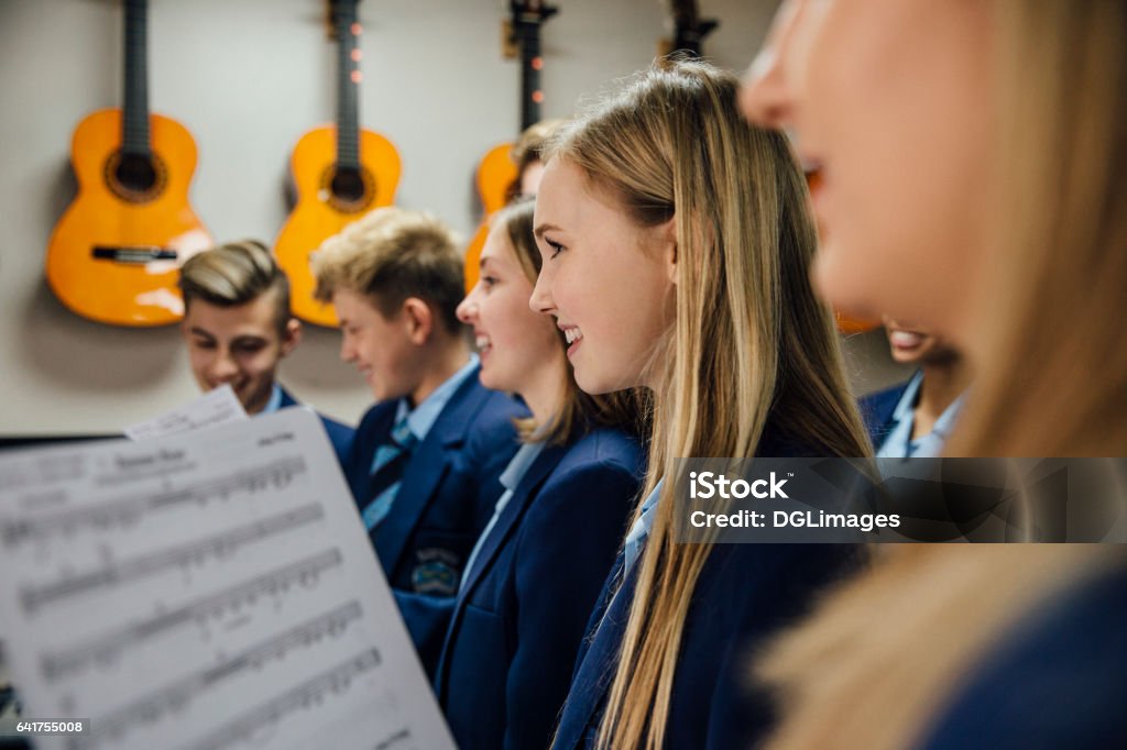 Music Lesson At School Close up shot of choir students singing in their music lesson at school. Choir Stock Photo