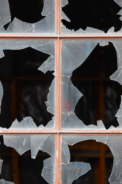 istock Damage window with broken glass and dark background. 641755030