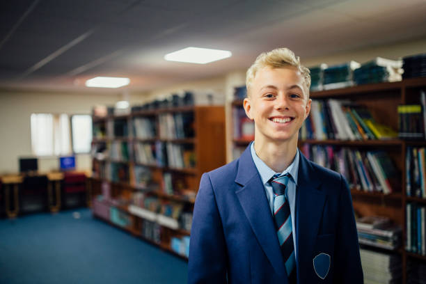 Teen Student In The Library Portrait of a teen student in the library of his school. Blazer stock pictures, royalty-free photos & images