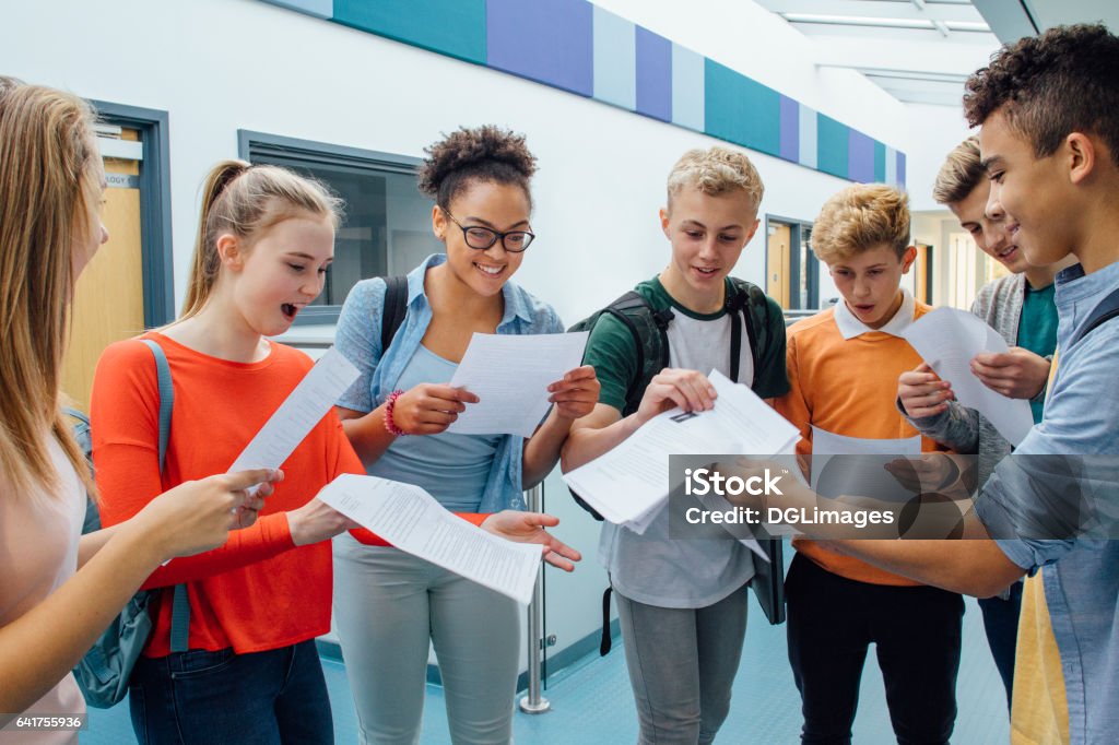 We All Passed! Happy students have received their exam results in high school. They are cheering and celebrating. Education Stock Photo