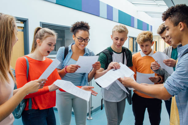 We All Passed! Happy students have received their exam results in high school. They are cheering and celebrating. good grades stock pictures, royalty-free photos & images