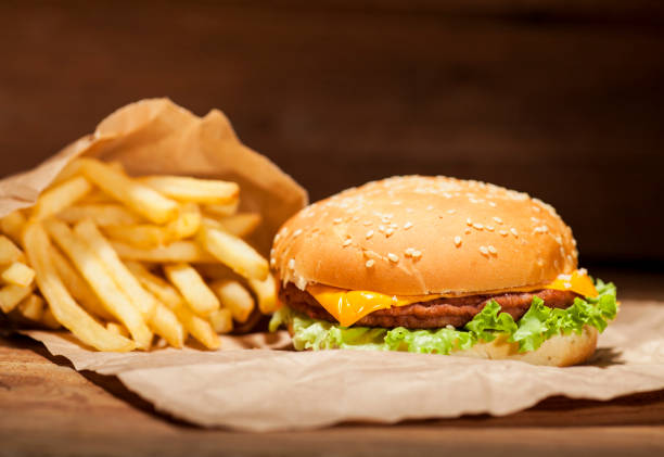 istock Fresh burger on wooden background 641756178
