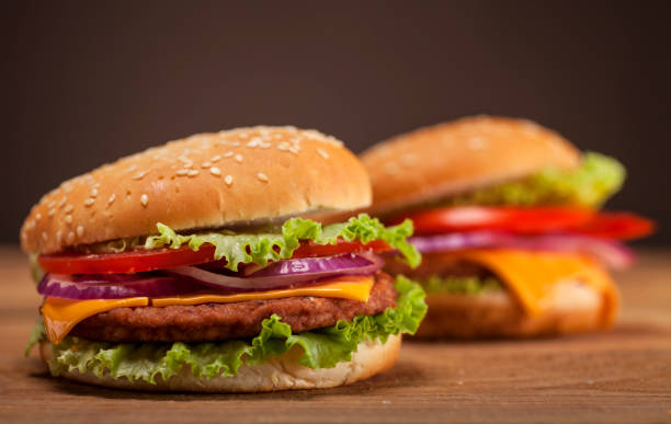 istock Fresh burgers on wooden background 641756202