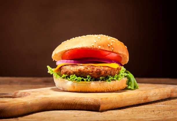 istock Fresh burger on wooden background 641756226
