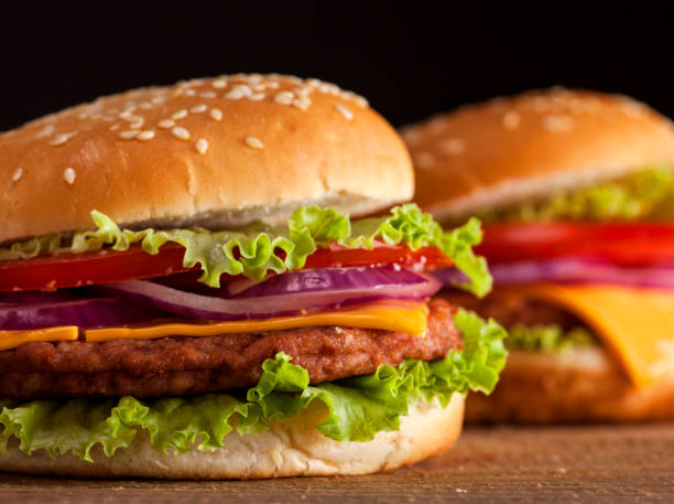 istock Fresh burgers on wooden background 641756244