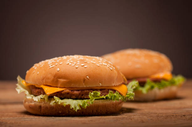 istock Fresh burgers on wooden table 641756264