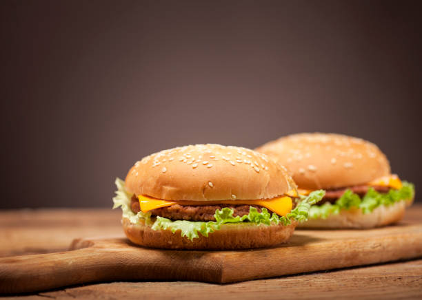 istock Fresh burgers on wooden table 641756274