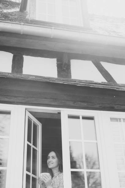 Smiling woman on the window looking away