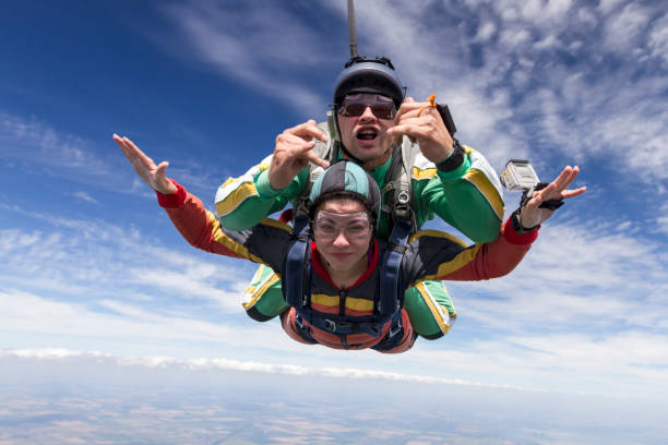 istock Tandem jump. The girl with the instructor in freefall. 641760414