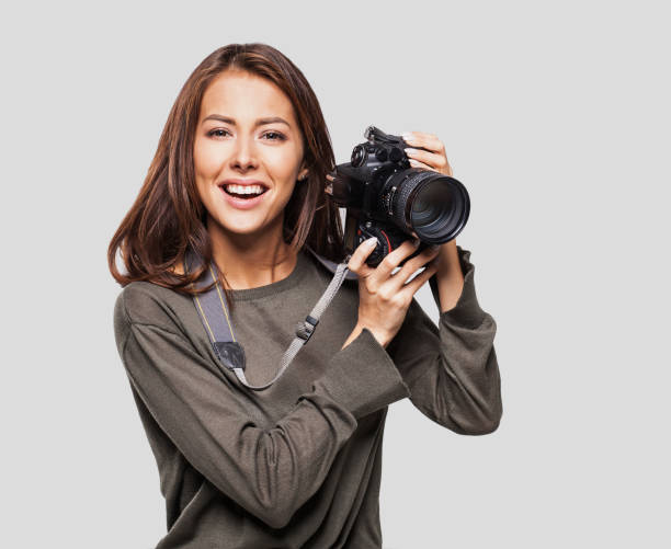 istock Woman photographer with dslr camera 641762316