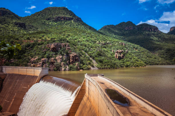 the swadini dam waterfall near the blyde river with the dragensberg as background