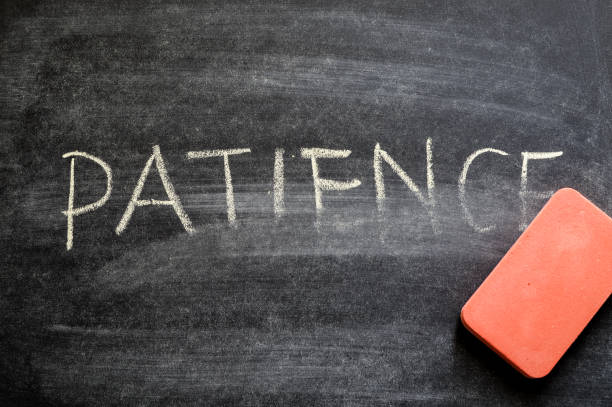 istock erasing patience, hand written word on blackboard being erased concept 641763530