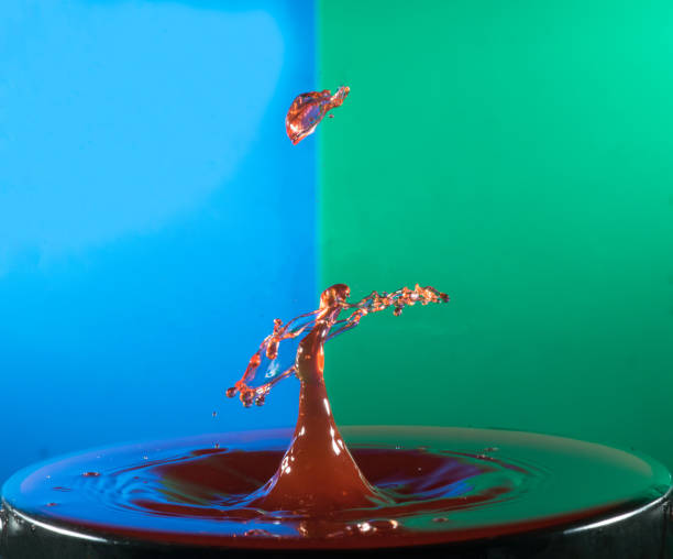 istock Collision of two drops on a surface of water 641764448
