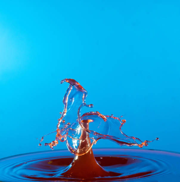 istock Collision of two drops on a surface of water 641764512