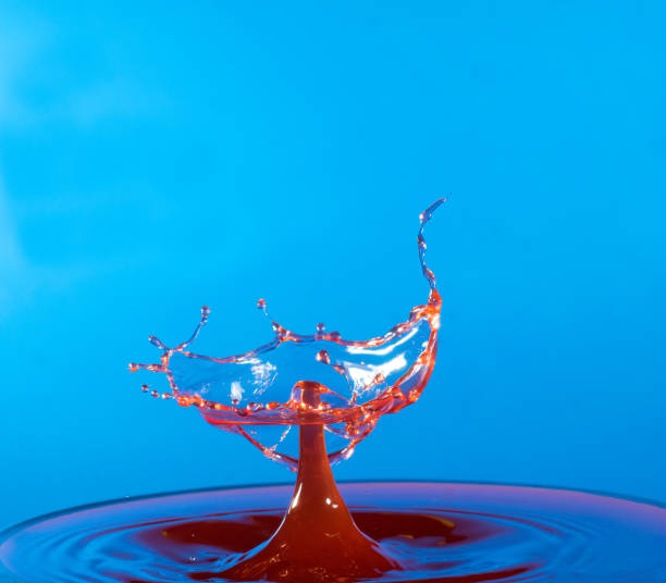 istock Collision of two drops on a surface of water 641764522