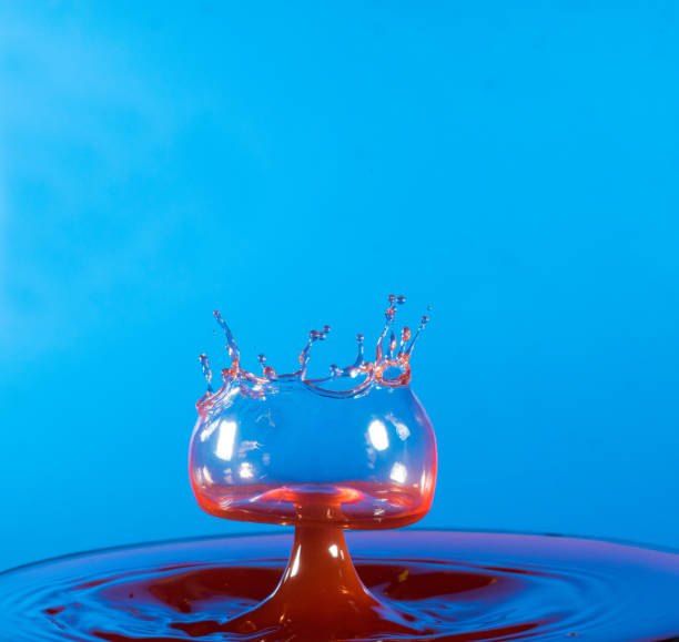 istock Collision of two drops on a surface of water 641764534