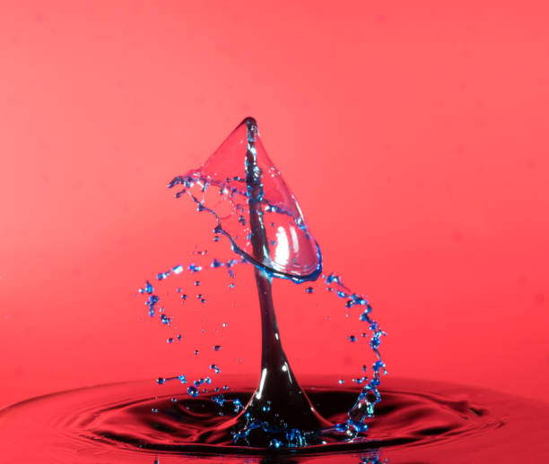 istock Collision of two drops on a surface of water 641764554