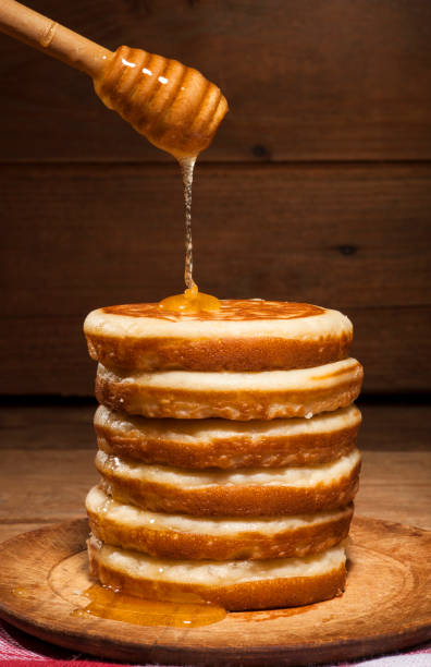 istock Pancakes with honey on wooden background 641765660