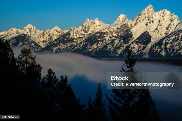 Grand Teton National Park In Morning Mist Stock Photo - Download Image Now - Alpenglow, Extreme Terrain, Fog