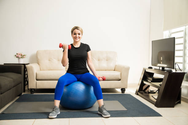 istock Cute Hispanic woman exercising at home 641768984