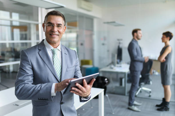 istock Mature businessman using digital tablet in the office 641769470