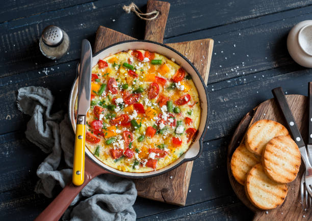 Vegetable frittata in a cast iron skillet on wooden background. Delicious brunch, top view Vegetable frittata in a cast iron skillet on wooden background. Delicious brunch, top view frittata stock pictures, royalty-free photos & images