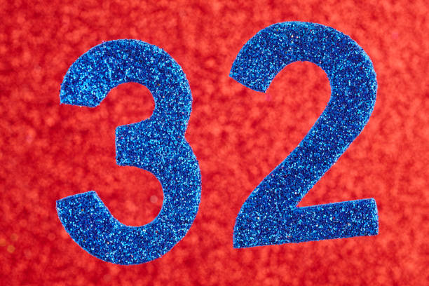 istock Number thirty-two blue color over a red background. Anniversary. 641771638