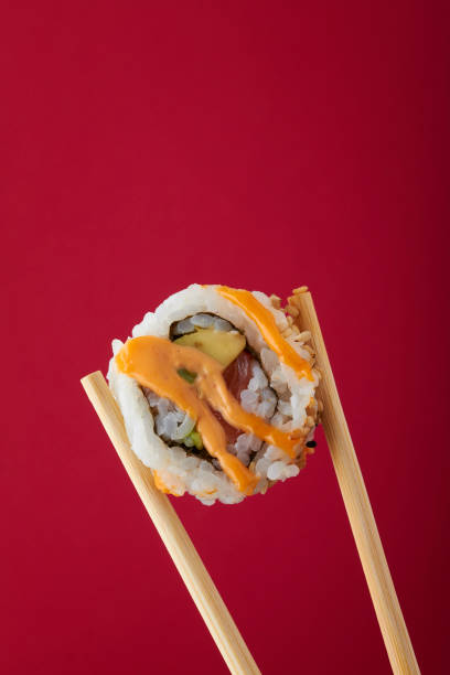 istock Bite of Sushi in chopsticks 641779940