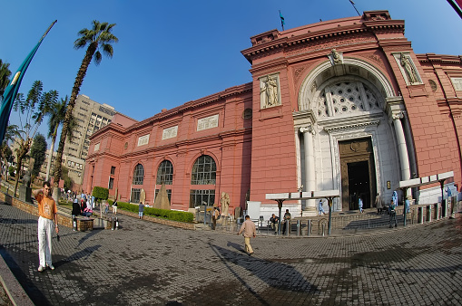 Cairo, Egypt - November 11, 2006: The Egyptian Museum in Cairo, one of the most famous museums of the world. Tourists come through the main entrance into the museum.