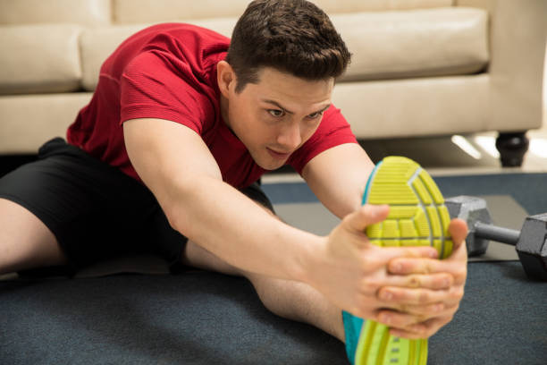 istock Man stretching his legs and working out 641785156